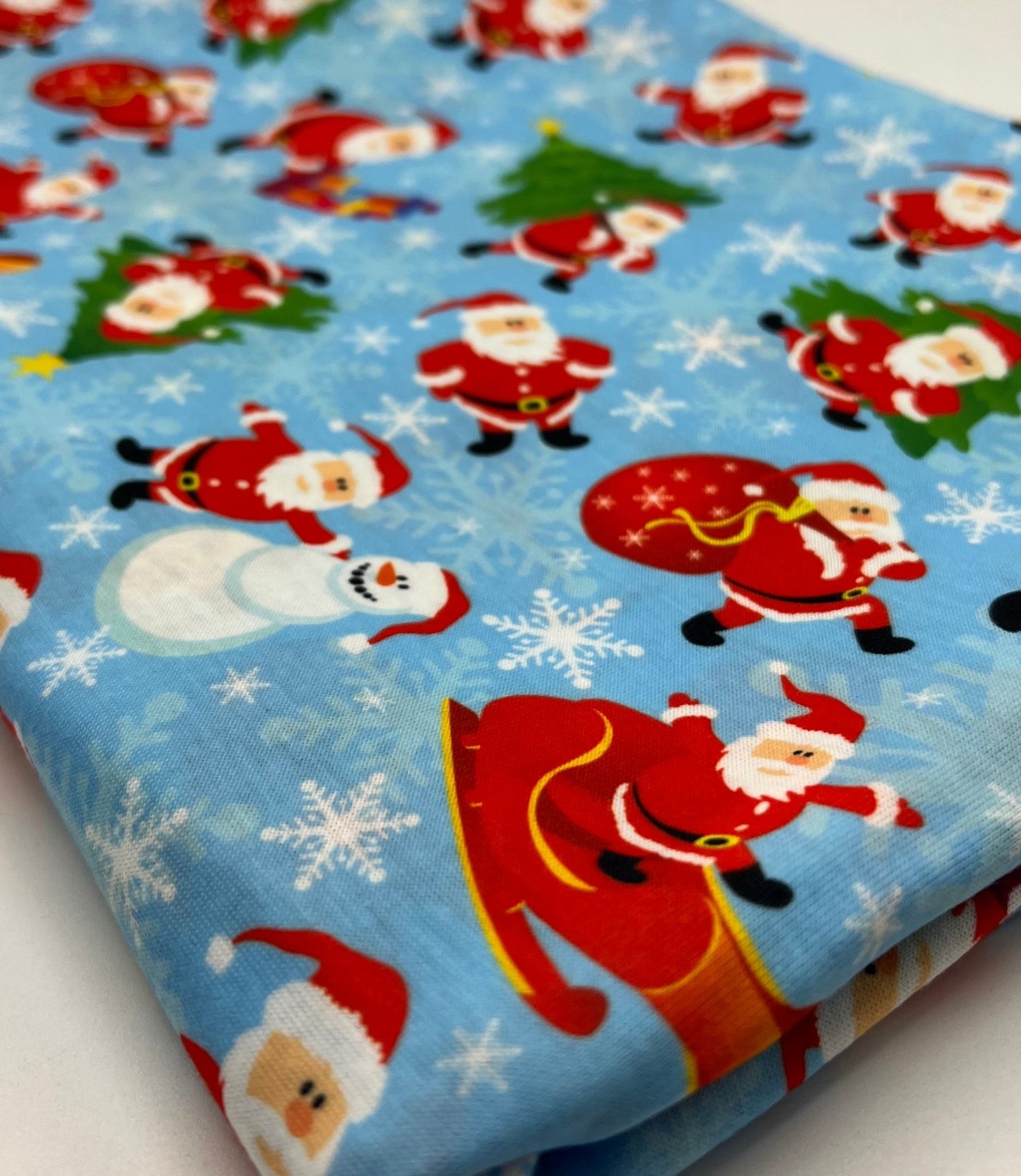 Blue Santa Sledge Print Soft Spun Poly Stretch Fabric - T9 Fabrics