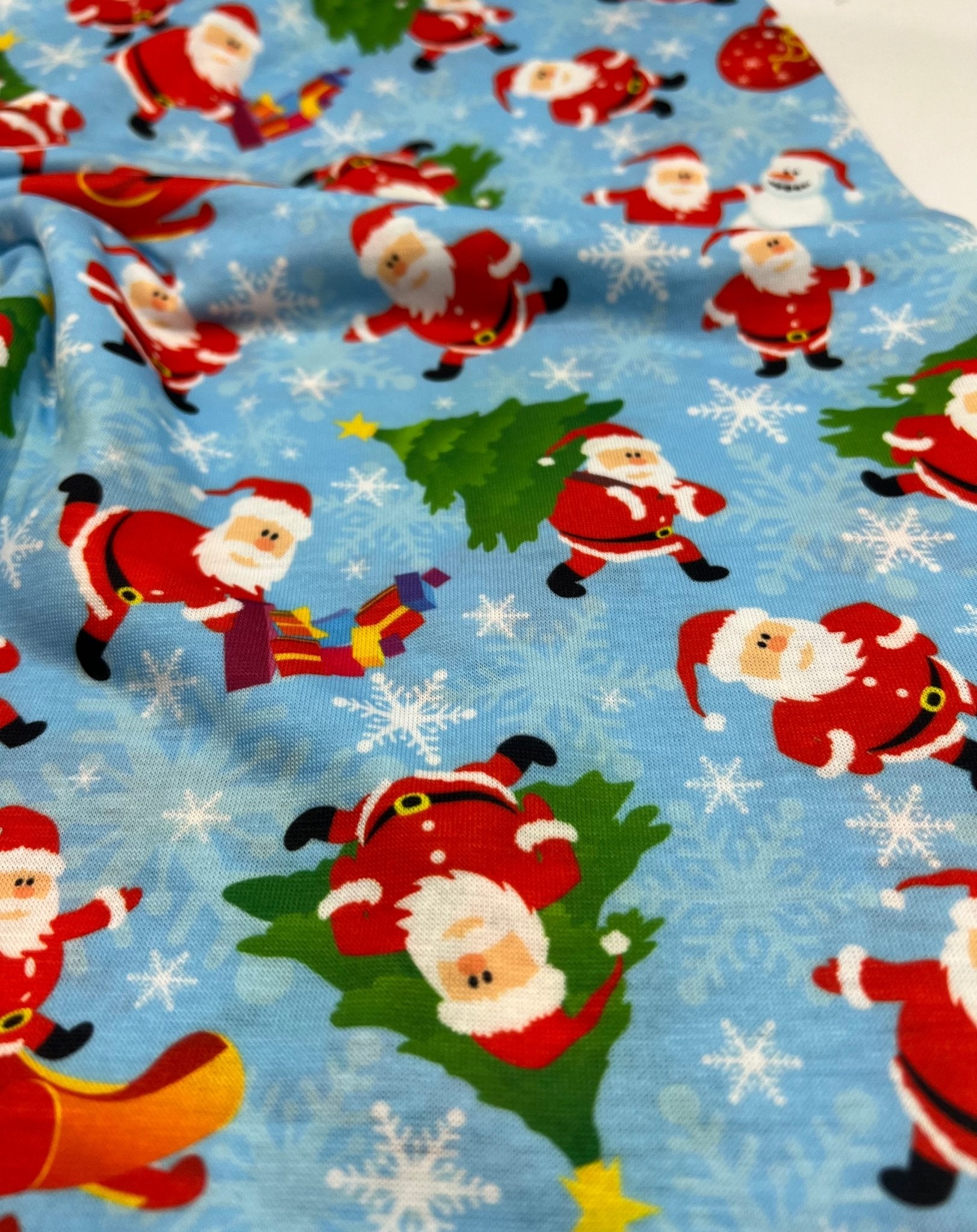 Blue Santa Sledge Print Soft Spun Poly Stretch Fabric - T9 Fabrics